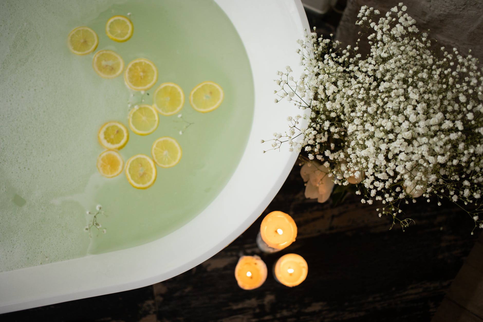 bathtub with candles and flowers